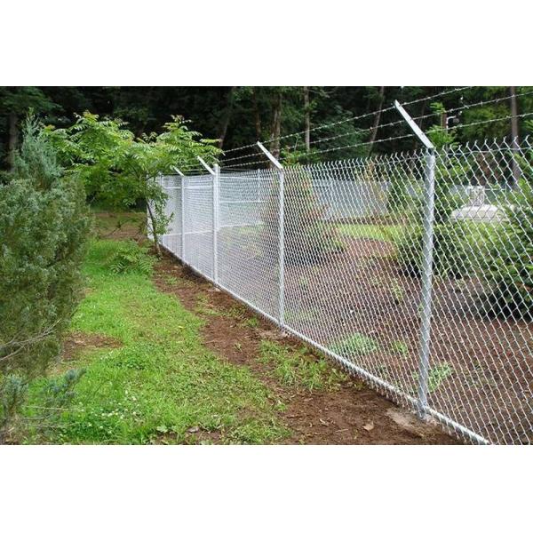 Security chain link fence with three strands of barbed wire to prevent turning.