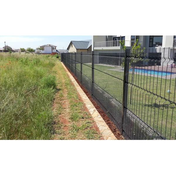Black polyester coated high security clearvu fence for house protection, grass land and a swimming pool in yard.