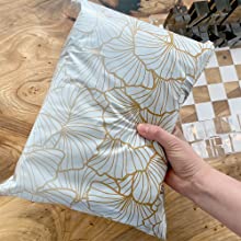 Hand holding ginkgo leaf poly mailer