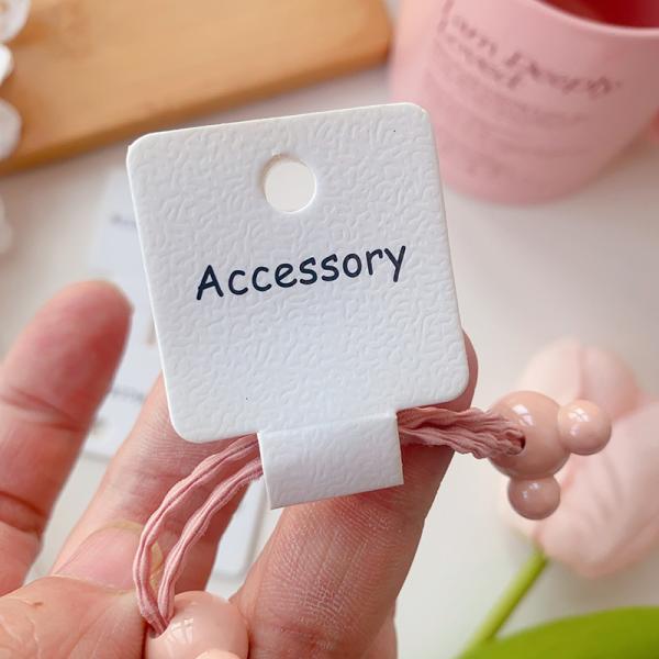 Buy Embossed Hair Tie Folding Cards Black Text 100pcs at wholesale prices