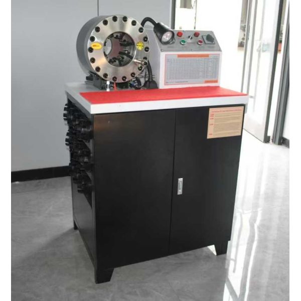 Rubber hose crimping machine close-up showing die mechanism