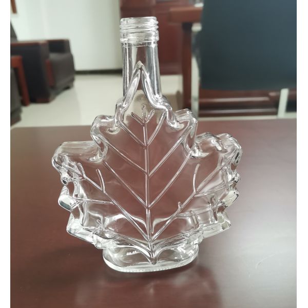 Buy High Borosilicate 25cl Leaf Shape Spirit Glass Bottle With Screw Cap at wholesale prices