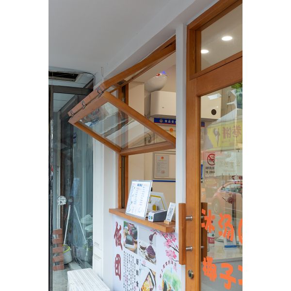 Cooking Station Folding Window Allowing Pass-Through Service to Outdoor Dining Areas During Entertaining